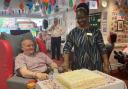 Craigielea Care Home resident Kenneth Hogan and deputy manager Dorica Mukuma cutting the cake