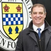 St Mirren hero hands over a number of cheques to charities