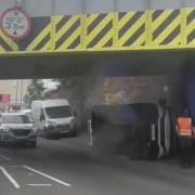 Van tips onto its side under railway bridge in Paisley
