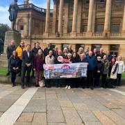 Business owners gathered outside Paisley's Town Hall last month with a petition aimed at saving the 'Free for Three' parking scheme