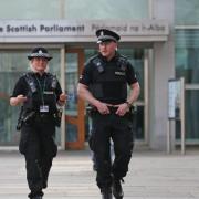 Police Scotland officers outside the Scottish parliament in Edinburgh