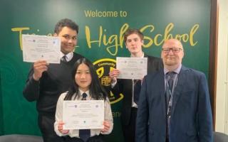 PC Andy Law with Trinity High pupils Ashley Li, Zack Zurek-Ali and Christian Morrison