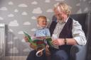 Author Norman Macdonald reading his new book Princey To The Rescue to his grandson Jude McGhee who had inspired him to write the story