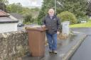 Councillor Chris Gilmour next to brown bin