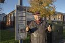 Councillor Andy Doig next to a bus stop in Lochwinnoch's Main Street
