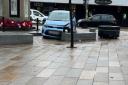 Car crashes into concrete bench in busy town centre