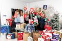Members of Taylor Wimpey West Scotland in their regional office in Paisley with 77 gift bags bound for The Renfrewshire Toy Bank