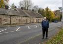 Councillor John Hood next to the old Quarrelton school building in Beith Road