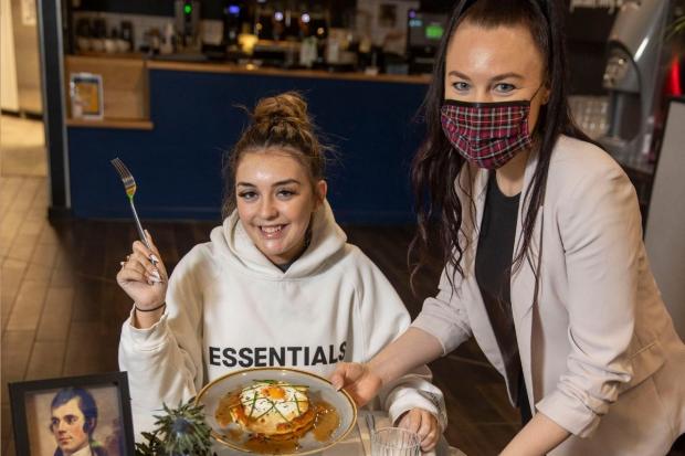 Kheara Dillon is served up a Burns Night Haggis Hash Toastie pancake by Meile Vainauskaite, at the Braehead Centre’s Stack and Still restaurant in honour of Scotland’s National Bard