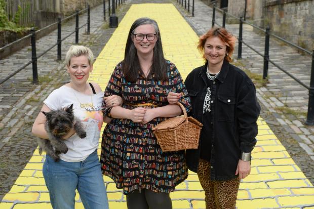 Lead artists Cora Bissett and Bex Anson, along with Cllr Lisa-Marie Hughes, step onto the yellow brick road to launch Oz! A Yellow Brick Road Adventure in Paisley