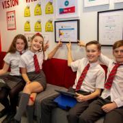 Pupils at Bargarran Primary show off the award won by the school for promoting digital inclusion