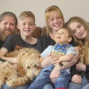 Five-year-old Bonham with mum Anna, dad Graeme, and siblings Elliot and Aimee and dog Ozzie at their Paisley home.