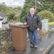 Councillor Chris Gilmour next to brown bin