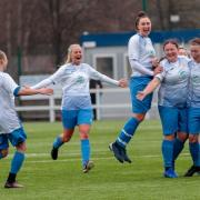 Claire Rae is surrounded by her jubilant teammates Photo: Allan Picken